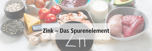 Zinkhaltige Speisen auf einem Tisch mit dem chemischen Symbol für Zink "Zn"